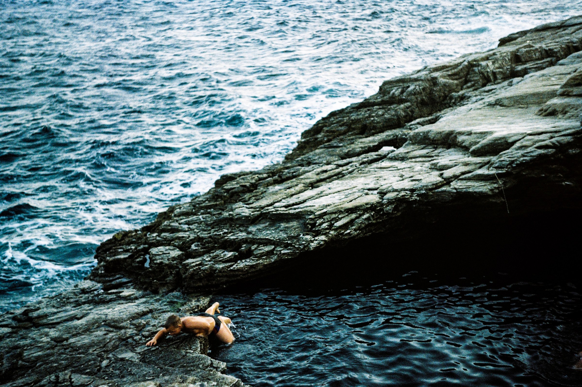 Person on rocks by the sea — film photography